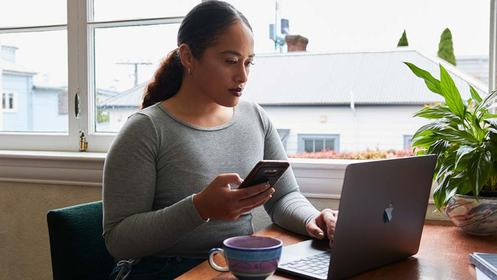 Woman using laptop in home environment